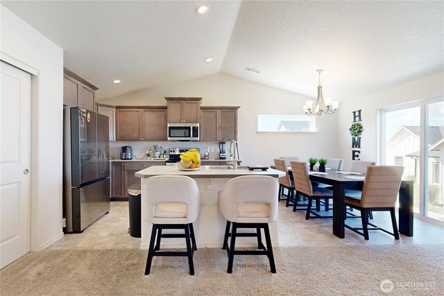 7 Patty Cir, Milton-Freewater, OR 97862 - kitchen with stainless steel appliances, vaulted ceiling, a chandelier, light countertops, and a kitchen breakfast bar