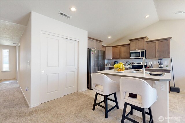 7 Patty Cir, Milton-Freewater, OR 97862 - kitchen with stainless steel appliances, a sink, light countertops, a breakfast bar, and vaulted ceiling
