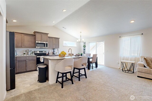 7 Patty Cir, Milton-Freewater, OR 97862 - kitchen featuring stainless steel appliances, a chandelier, lofted ceiling, a breakfast bar area, and a sink