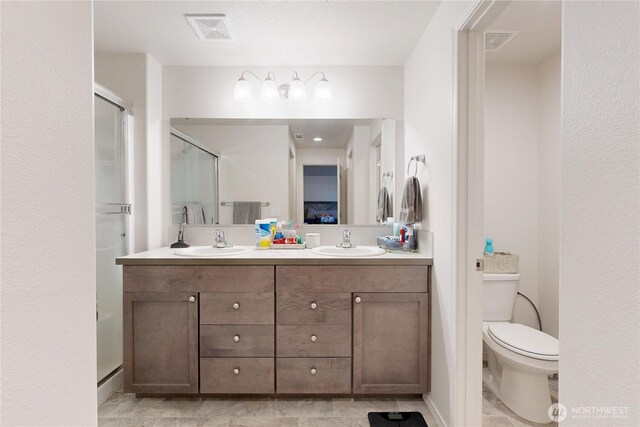 7 Patty Cir, Milton-Freewater, OR 97862 - bathroom featuring a shower stall, double vanity, and toilet