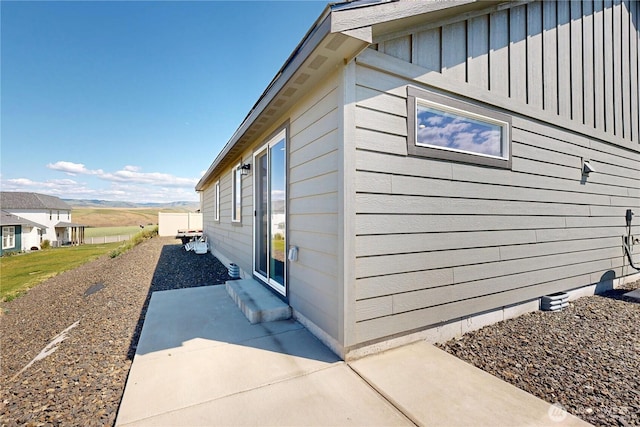 7 Patty Cir, Milton-Freewater, OR 97862 - view of side of property featuring board and batten siding and a patio