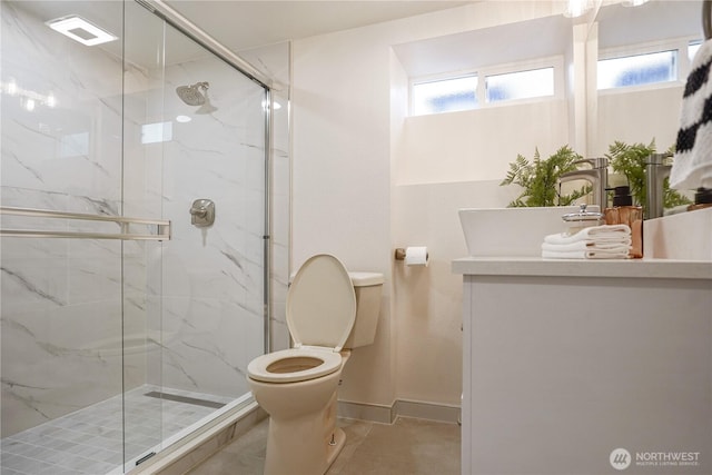 5909 8th Ave NW, Seattle, WA 98107 - full bathroom featuring toilet, a sink, a marble finish shower, and baseboards