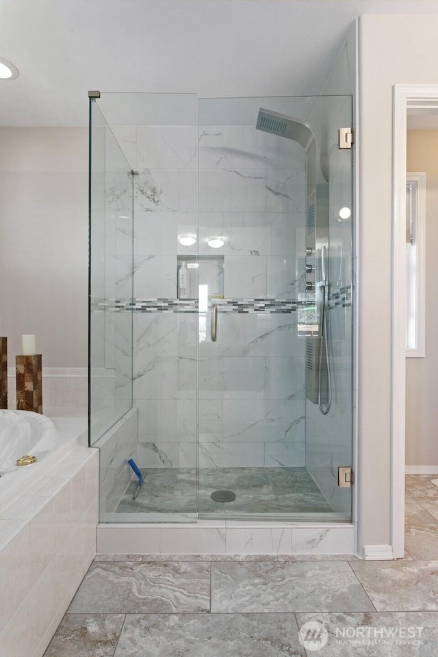 1022 S 225th Ln, Des Moines, WA 98198 - full bathroom featuring a marble finish shower, a garden tub, and marble look tiles