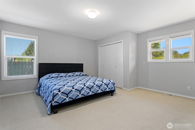 1022 S 225th Ln, Des Moines, WA 98198 - carpeted bedroom featuring multiple windows and a closet