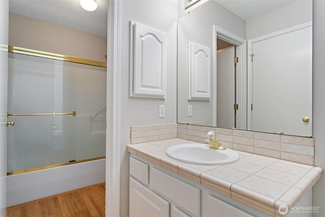 1022 S 225th Ln, Des Moines, WA 98198 - bathroom with vanity, wood finished floors, and shower / bath combination with glass door