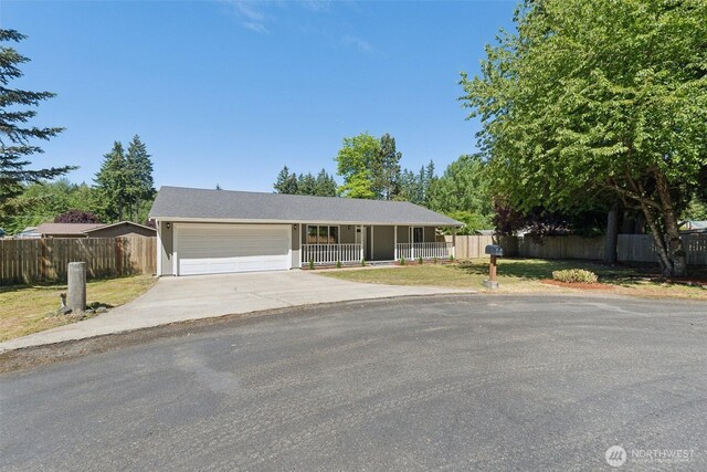 7115 239th Ct E, Graham, WA 98338 - single story home with driveway, a garage, and a porch
