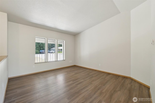 7115 239th Ct E, Graham, WA 98338 - empty room with wood finished floors and baseboards