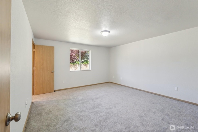 7115 239th Ct E, Graham, WA 98338 - carpeted empty room featuring a textured ceiling and baseboards