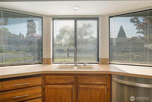 5201 S M St, Tacoma, WA 98408 - kitchen with dishwasher, a sink, light countertops, and brown cabinetry