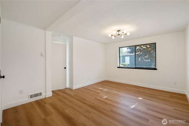 5201 S M St, Tacoma, WA 98408 - unfurnished room featuring wood finished floors, a chandelier, and baseboards