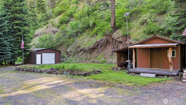 136 Tamarack Ln, Dayton, WA 99328 - view of yard featuring an outbuilding, a view of trees, and a garage