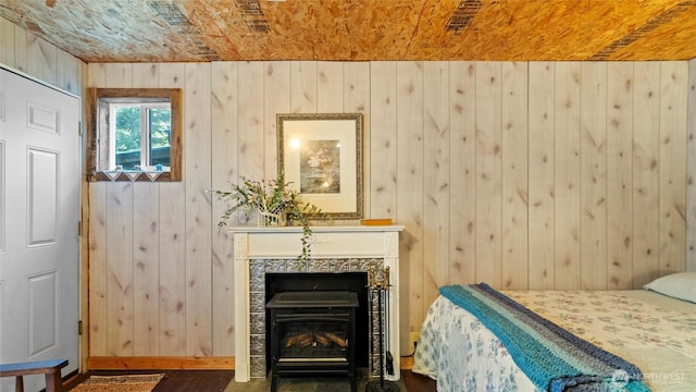 136 Tamarack Ln, Dayton, WA 99328 - bedroom featuring wood walls, baseboards, and a tiled fireplace