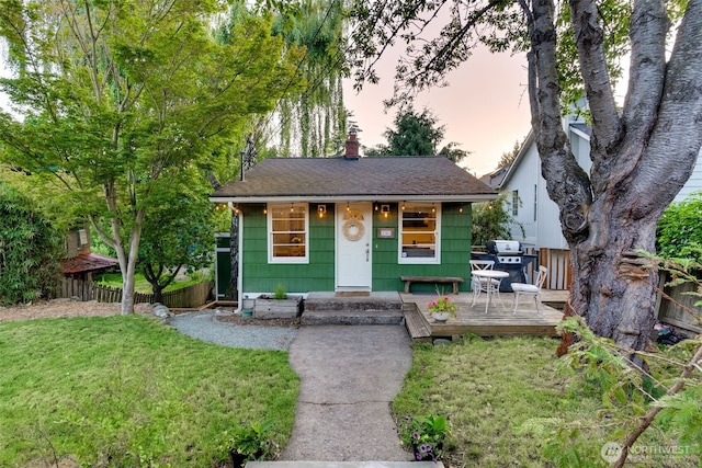 9741 Densmore Ave N, Seattle, WA 98103 - bungalow-style house with a deck, roof with shingles, and a chimney