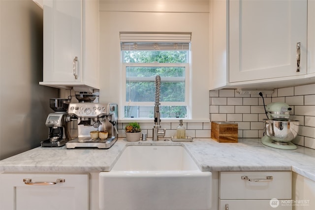 9741 Densmore Ave N, Seattle, WA 98103 - kitchen featuring white cabinets, backsplash, and light stone counters