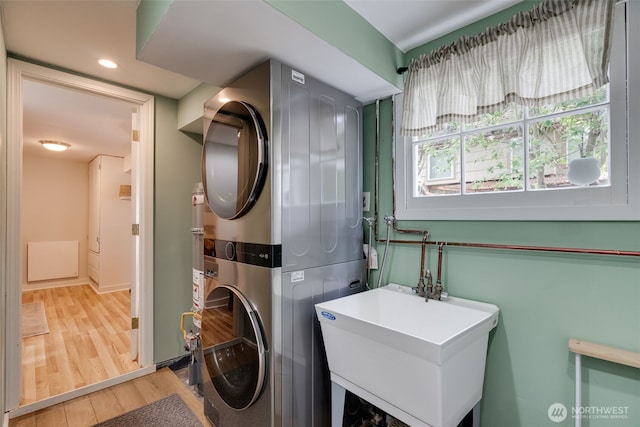 9741 Densmore Ave N, Seattle, WA 98103 - washroom with estacked washer and dryer, wood finished floors, and recessed lighting