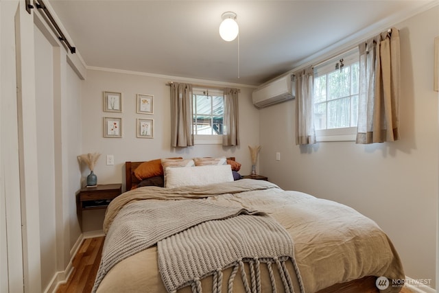 9741 Densmore Ave N, Seattle, WA 98103 - bedroom with a wall mounted air conditioner, wood finished floors, multiple windows, crown molding, and a barn door