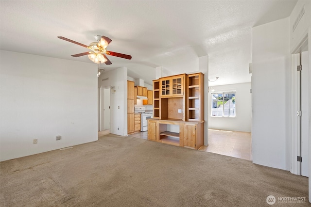 7220 E Belmont St, Othello, WA 99344 - unfurnished living room featuring a ceiling fan, light colored carpet, and vaulted ceiling