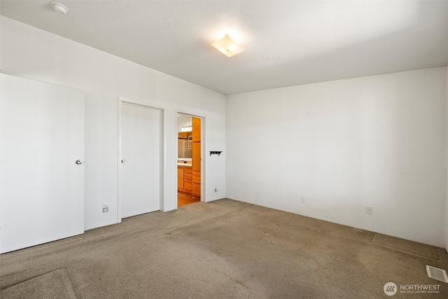 7220 E Belmont St, Othello, WA 99344 - unfurnished bedroom featuring carpet floors and ensuite bath