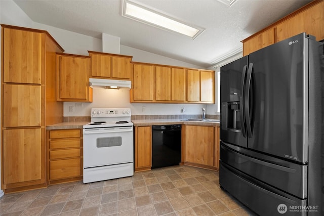 7220 E Belmont St, Othello, WA 99344 - kitchen featuring black appliances, under cabinet range hood, vaulted ceiling, a sink, and light countertops