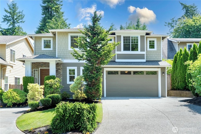 8910 125th Ln NE, Kirkland, WA 98033 - view of front of home featuring concrete driveway, a garage, and stone siding