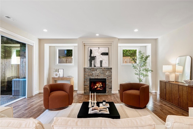 8910 125th Ln NE, Kirkland, WA 98033 - living room with wood finished floors, a stone fireplace, and recessed lighting