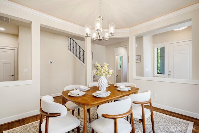 8910 125th Ln NE, Kirkland, WA 98033 - dining space featuring a chandelier, wood finished floors, ornamental molding, and stairway