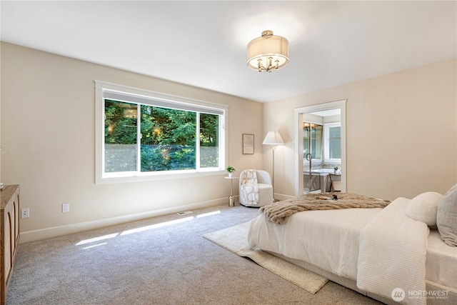 8910 125th Ln NE, Kirkland, WA 98033 - carpeted bedroom with a chandelier and connected bathroom