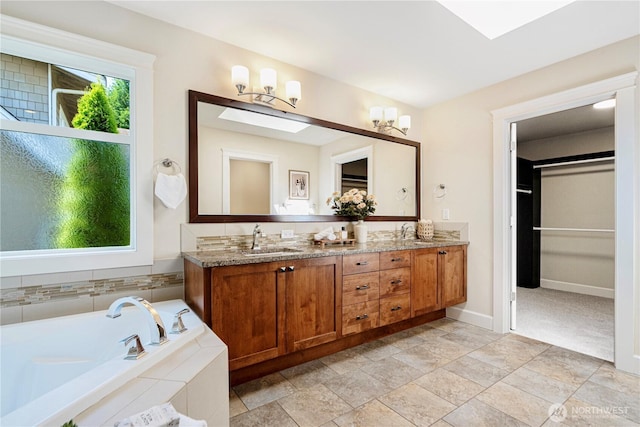 8910 125th Ln NE, Kirkland, WA 98033 - full bath with double vanity, a bath, a spacious closet, and stone finish flooring