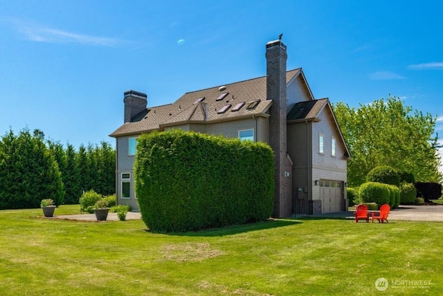 794 W Smith Rd, Bellingham, WA 98226 - view of side of home with a chimney, an attached garage, and a lawn