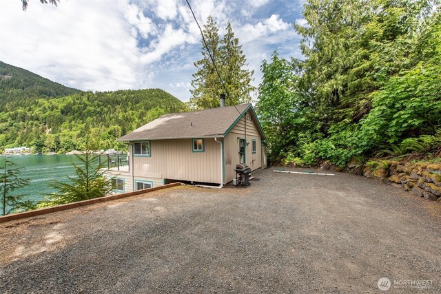 49 Sunny Point Ln, Port Angeles, WA 98363 - back of property featuring a view of trees and a water view