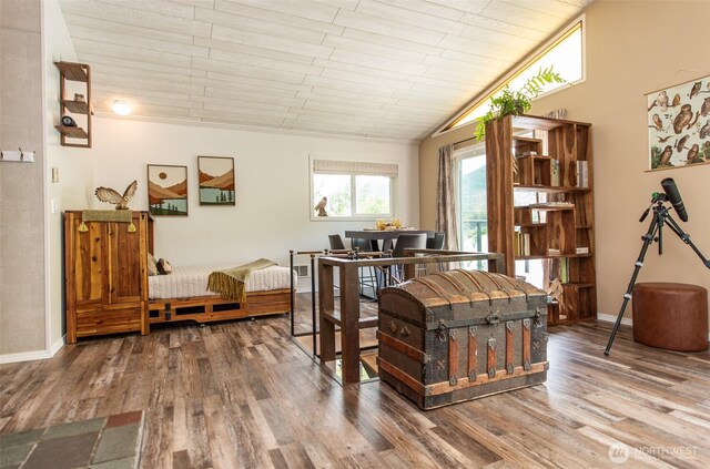 49 Sunny Point Ln, Port Angeles, WA 98363 - dining room featuring wood finished floors, vaulted ceiling, and baseboards
