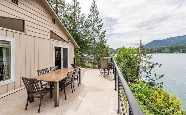 49 Sunny Point Ln, Port Angeles, WA 98363 - view of patio with a water and mountain view, a balcony, and outdoor dining area
