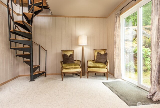 49 Sunny Point Ln, Port Angeles, WA 98363 - living area featuring healthy amount of natural light, stairs, carpet, wooden walls, and baseboards