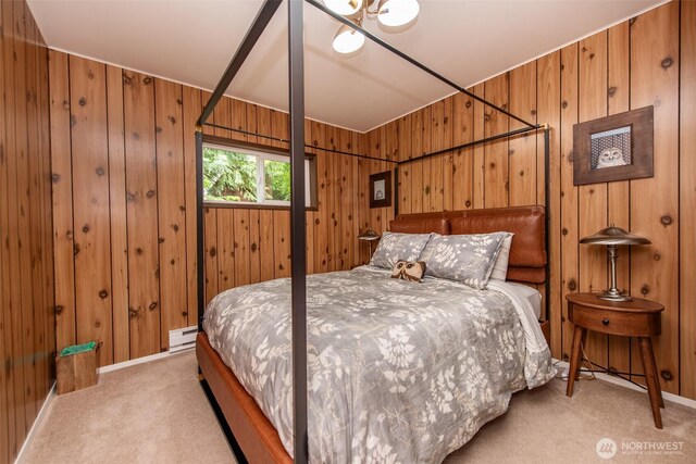 49 Sunny Point Ln, Port Angeles, WA 98363 - bedroom with light carpet, wood walls, baseboard heating, and baseboards