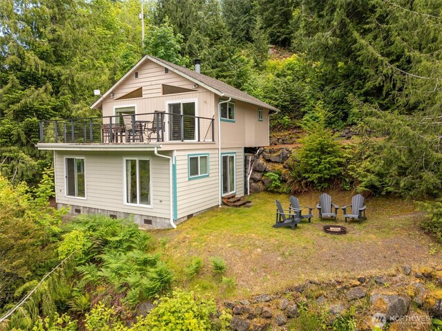 49 Sunny Point Ln, Port Angeles, WA 98363 - back of property with a balcony, a fire pit, a wooded view, crawl space, and a yard