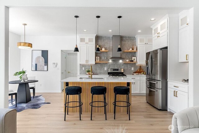 24212 112th Ave SE, Kent, WA 98030 - kitchen featuring stainless steel appliances, a sink, wall chimney range hood, open shelves, and light countertops