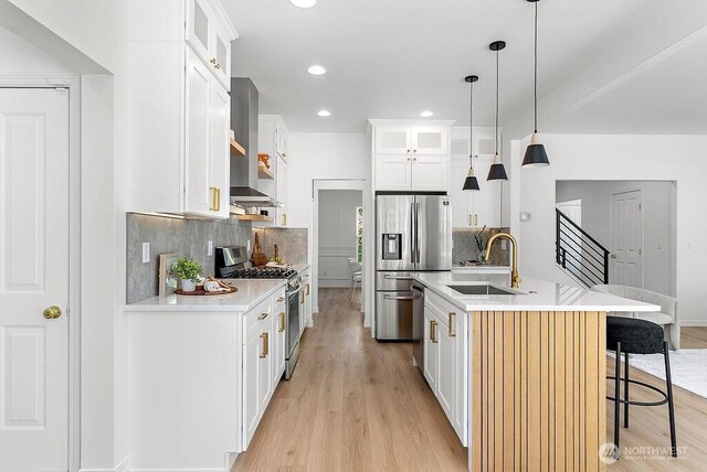 24212 112th Ave SE, Kent, WA 98030 - kitchen with stainless steel appliances, a sink, light wood-style floors, a kitchen island with sink, and recessed lighting