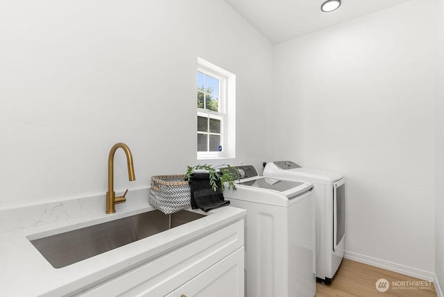 24212 112th Ave SE, Kent, WA 98030 - laundry area featuring washer and dryer, light wood-style floors, and baseboards