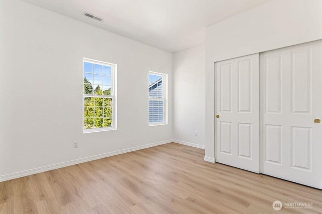 24212 112th Ave SE, Kent, WA 98030 - unfurnished bedroom with light wood-style floors, baseboards, and a closet