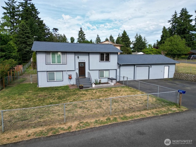 1306 Makah St NE, Olympia, WA 98516 - bi-level home featuring asphalt driveway and an attached garage