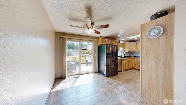 1306 Makah St NE, Olympia, WA 98516 - kitchen featuring stainless steel appliances, a ceiling fan, a sink, a textured ceiling, and a textured wall