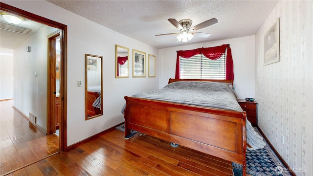 1306 Makah St NE, Olympia, WA 98516 - bedroom featuring hardwood / wood-style flooring, a textured ceiling, baseboards, and a ceiling fan