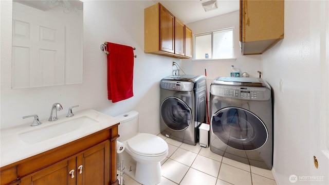 1306 Makah St NE, Olympia, WA 98516 - bathroom with washing machine and dryer, toilet, vanity, and tile patterned floors