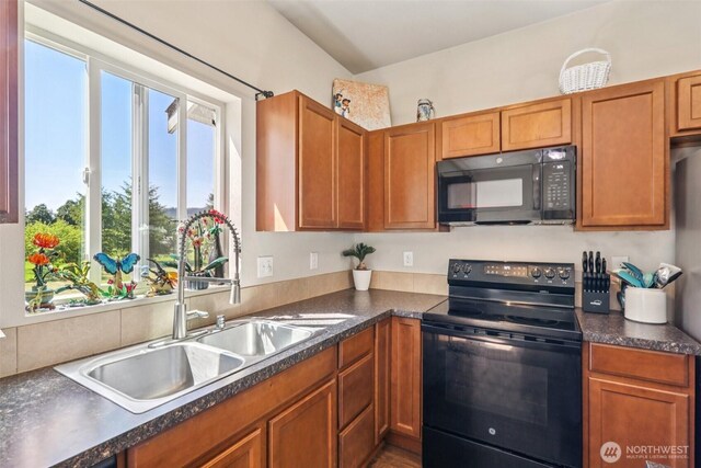 38431 147th St SE, Gold Bar, WA 98251 - kitchen featuring black appliances, dark countertops, and brown cabinetry