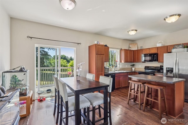38431 147th St SE, Gold Bar, WA 98251 - kitchen featuring black appliances, healthy amount of natural light, dark countertops, and dark wood-style floors