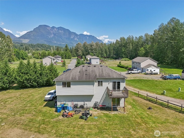 38431 147th St SE, Gold Bar, WA 98251 - rear view of property with a deck with mountain view, a wooded view, and roof with shingles