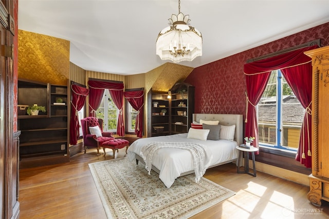 925 Wilson St, Port Townsend, WA 98368 - bedroom with wallpapered walls, a chandelier, and wood finished floors