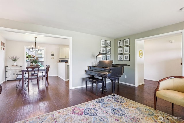 6413 152nd Ave E, Sumner, WA 98390 - living room featuring a chandelier, wood finished floors, and baseboards