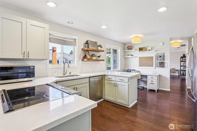 6413 152nd Ave E, Sumner, WA 98390 - kitchen featuring stainless steel appliances, a sink, dark wood-type flooring, open shelves, and healthy amount of natural light