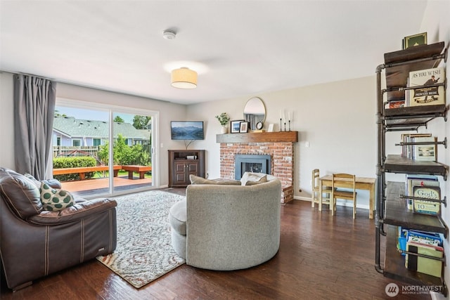 6413 152nd Ave E, Sumner, WA 98390 - living room featuring a fireplace, dark wood-type flooring, and baseboards